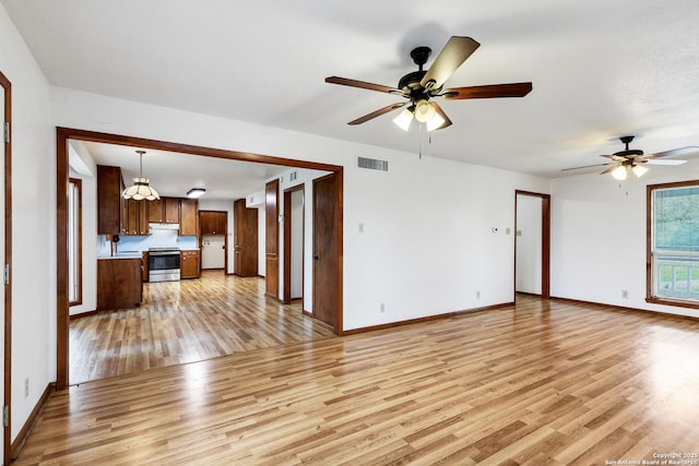 unfurnished living room featuring ceiling fan and light hardwood / wood-style flooring