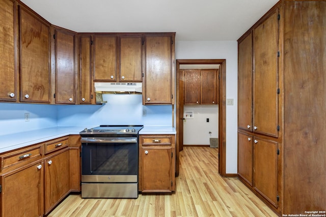 kitchen featuring stainless steel electric range and light hardwood / wood-style flooring