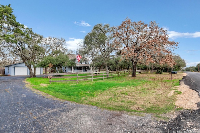 view of front of home featuring a front yard and a rural view