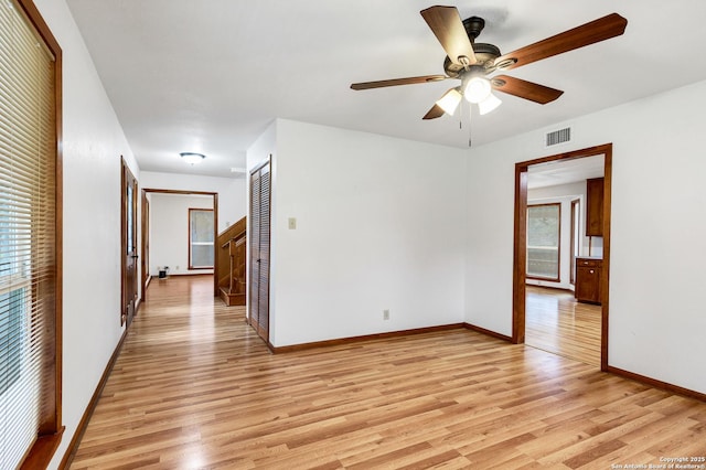 empty room featuring ceiling fan and light wood-type flooring