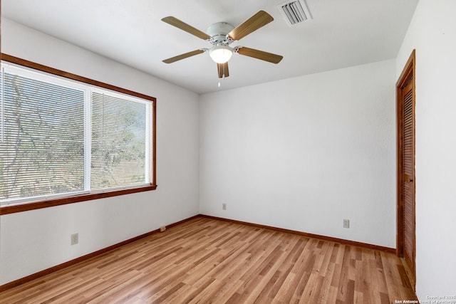 empty room featuring ceiling fan and light hardwood / wood-style flooring