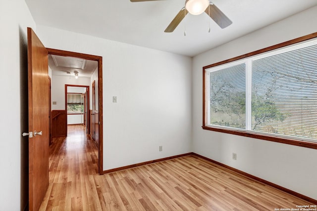 spare room with ceiling fan and light wood-type flooring