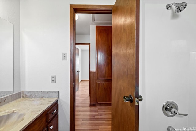 bathroom with vanity and hardwood / wood-style floors