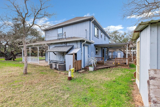 back of house with a wooden deck, central AC unit, and a lawn