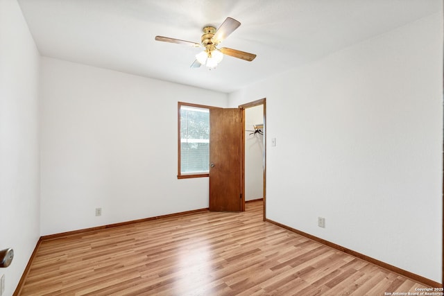 empty room featuring ceiling fan and light hardwood / wood-style flooring