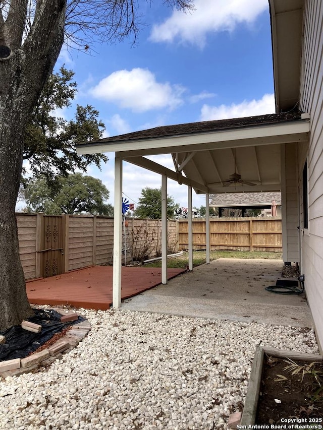 view of yard with a patio, a wooden deck, and ceiling fan