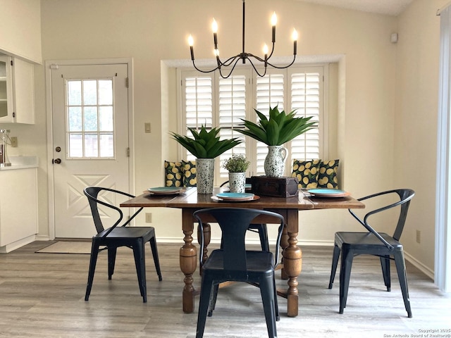 dining area featuring an inviting chandelier and wood-type flooring