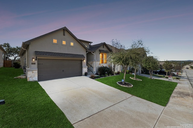 view of front facade with a garage and a yard