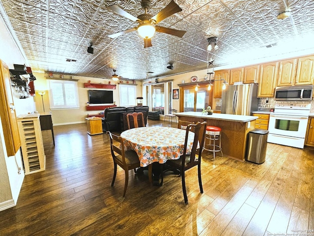 dining room with an ornate ceiling, visible vents, baseboards, and wood finished floors