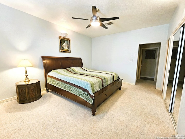 carpeted bedroom with visible vents, ceiling fan, a textured ceiling, and baseboards