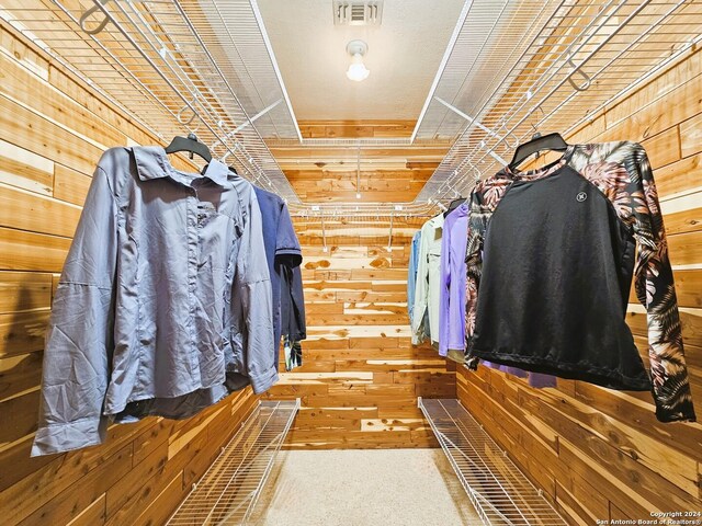 spacious closet featuring carpet flooring and visible vents