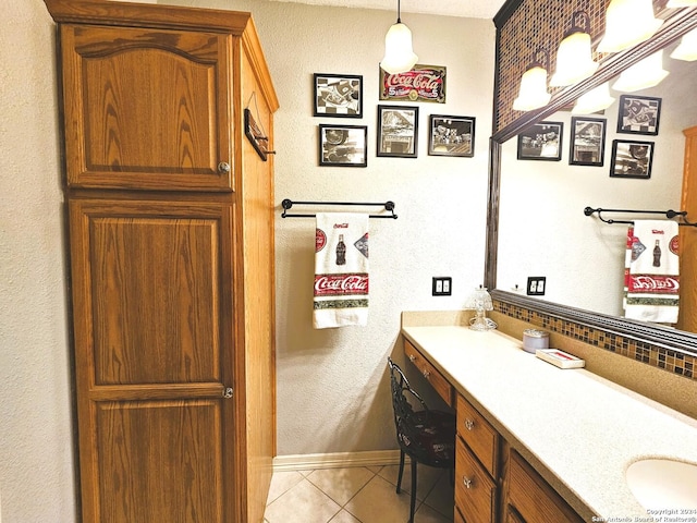 bathroom featuring tile patterned flooring, vanity, and baseboards