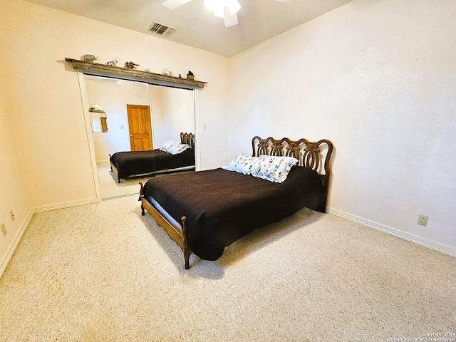 bedroom with ceiling fan, visible vents, baseboards, a closet, and carpet