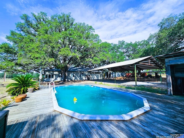 outdoor pool with a wooden deck