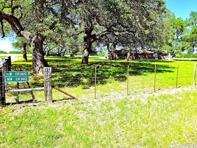 exterior space featuring fence and a rural view