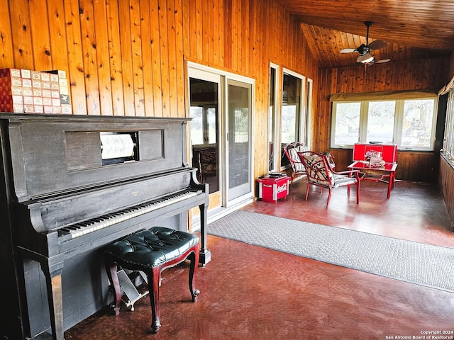 sunroom / solarium with a ceiling fan, wood ceiling, and vaulted ceiling