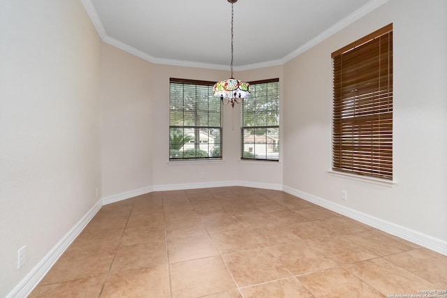 tiled empty room featuring a notable chandelier and ornamental molding