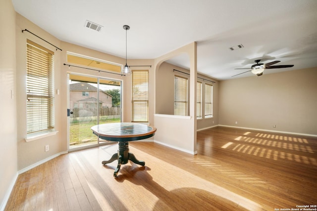 unfurnished dining area featuring ceiling fan and light wood-type flooring