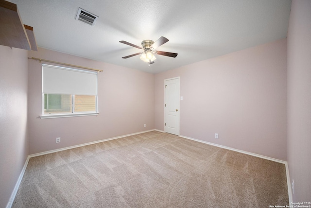 empty room with light colored carpet and ceiling fan