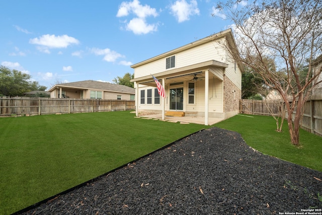 rear view of house with a patio, a yard, and ceiling fan