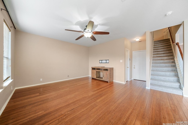 unfurnished living room with hardwood / wood-style flooring and ceiling fan