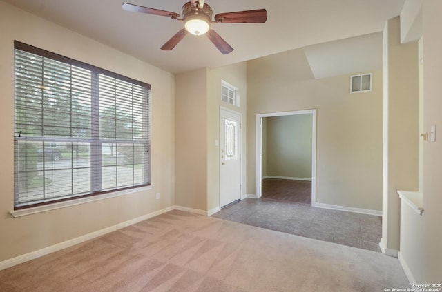 carpeted empty room featuring ceiling fan