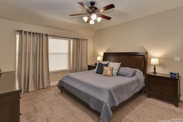 carpeted bedroom featuring vaulted ceiling and ceiling fan