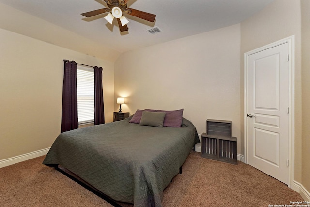 bedroom with ceiling fan, lofted ceiling, and carpet floors