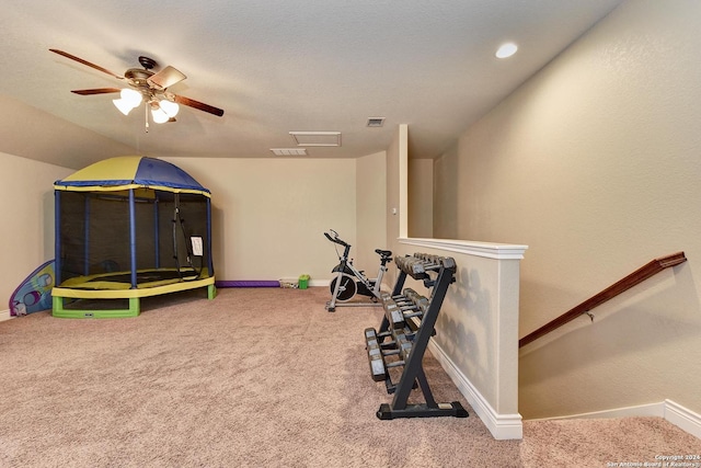 exercise area with ceiling fan and carpet flooring