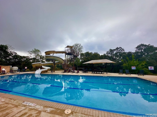 view of pool with a water slide