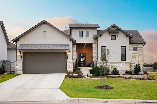 view of front of house with a garage and a yard