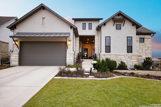 view of front of property with a yard and a garage