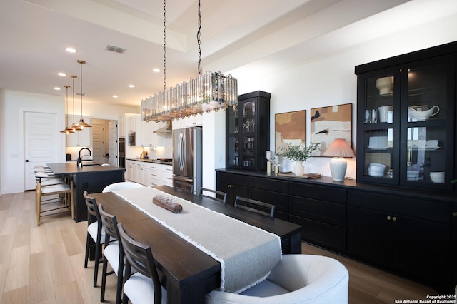 dining area featuring sink and light hardwood / wood-style floors