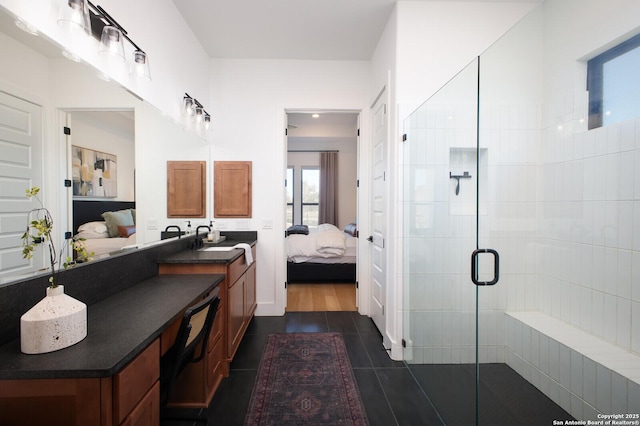 bathroom featuring vanity, tile patterned flooring, and a shower with door