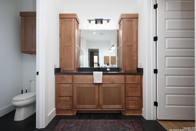 bathroom with vanity, tile patterned floors, and toilet