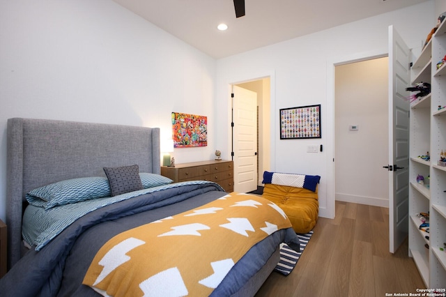 bedroom featuring light hardwood / wood-style flooring and ceiling fan