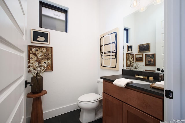 bathroom with vanity, tile patterned flooring, and toilet