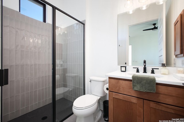 bathroom with vanity, a shower with door, and toilet