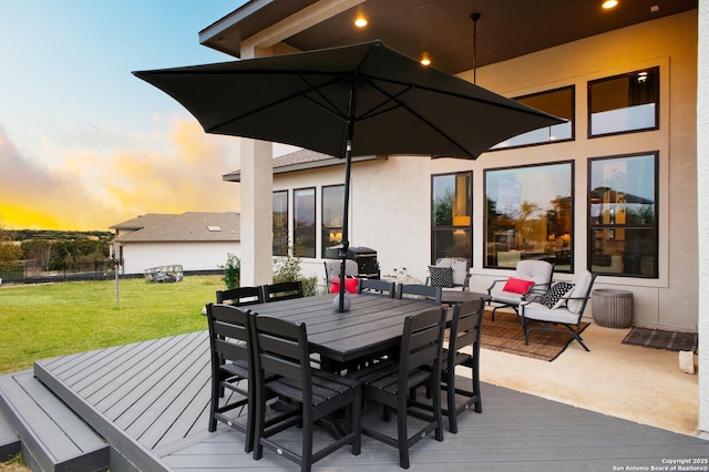 deck at dusk with a lawn