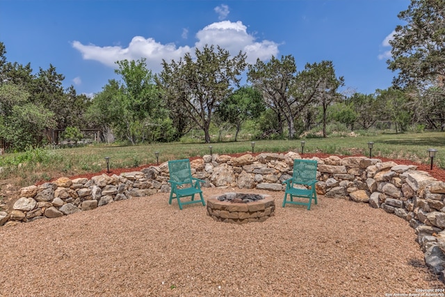 view of yard featuring an outdoor fire pit