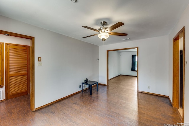 spare room with ceiling fan and dark hardwood / wood-style floors