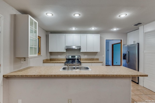 kitchen with white cabinetry, sink, stainless steel appliances, and kitchen peninsula