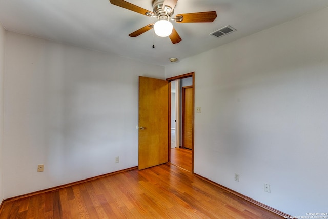 unfurnished room with ceiling fan and light wood-type flooring