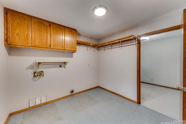 laundry area with hookup for a washing machine, hookup for an electric dryer, and cabinets