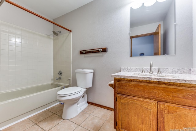 full bathroom with tiled shower / bath, tile patterned floors, toilet, and vanity