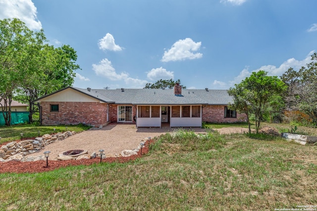 back of house featuring a patio and a lawn