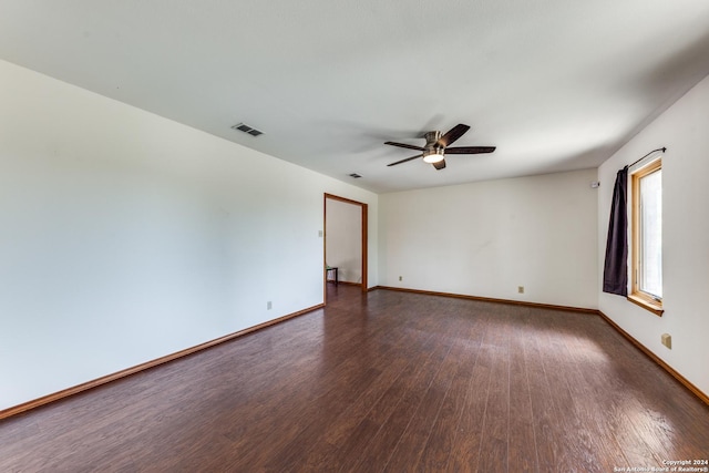 spare room featuring ceiling fan and dark hardwood / wood-style floors