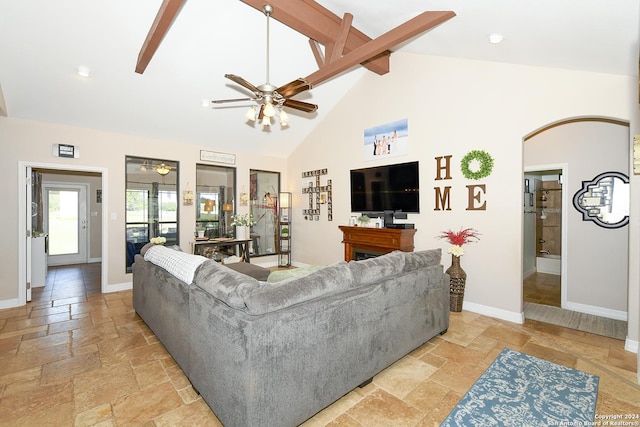 living room featuring ceiling fan and high vaulted ceiling