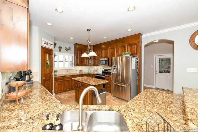 kitchen with sink, decorative backsplash, stainless steel appliances, and light stone countertops