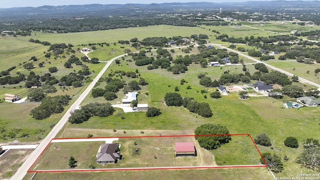 birds eye view of property with a rural view